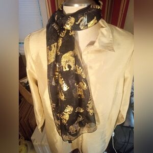 Sheer black neck scarf with bold, golden Elephants.